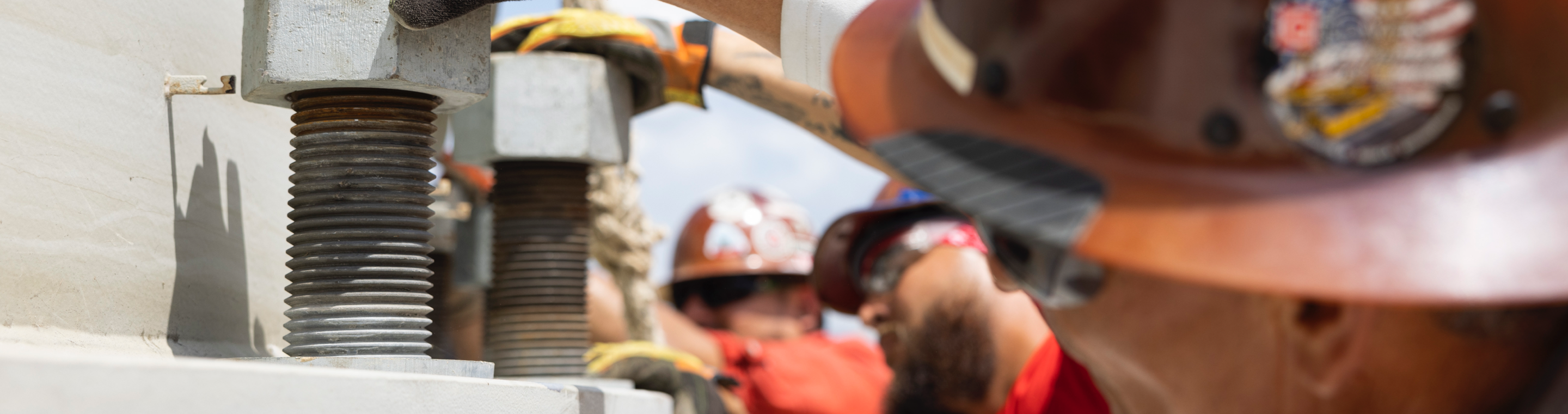 Engineers in safety gear inspect equipment